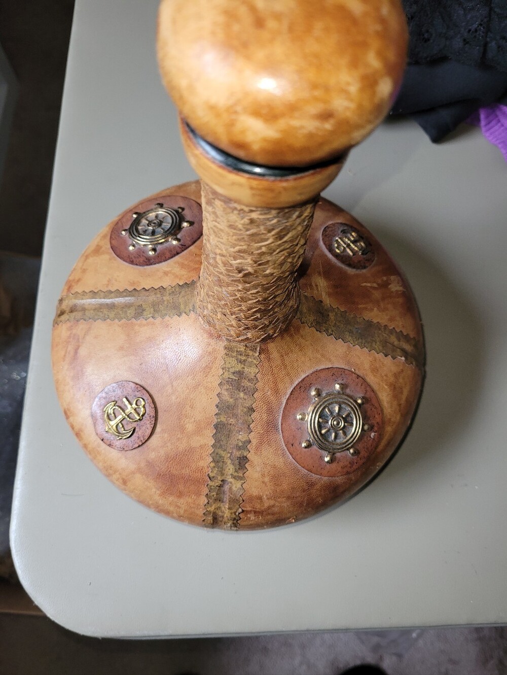 Vintage-Inspired Brown Leather Bound Decorative Bottle with Nautical Accents.